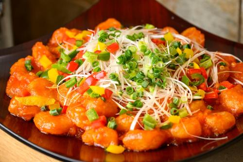 a plate of food with shrimp and vegetables on a table at Hotel Forza Oita in Oita