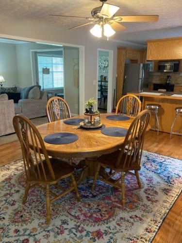 a dining room table and chairs in a living room at Quiet Kennesaw 3BR home - close to KSU, Lakepoint in Kennesaw