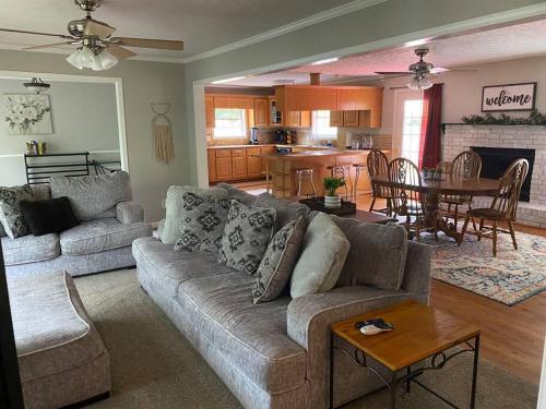 a living room with a couch and a table at Quiet Kennesaw 3BR home - close to KSU, Lakepoint in Kennesaw