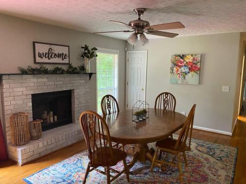 a dining room with a table and chairs and a fireplace at Quiet Kennesaw 3BR home - close to KSU, Lakepoint in Kennesaw