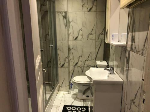 a bathroom with a toilet and a sink and a shower at Taksim Cihangir Apartment Luxury in Beyoglu