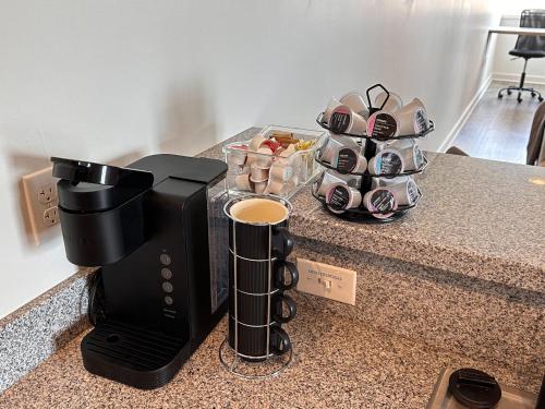 a coffee maker on a counter with a tray of dishes at Stylish Downtown High-Rise - 2BD in Baton Rouge