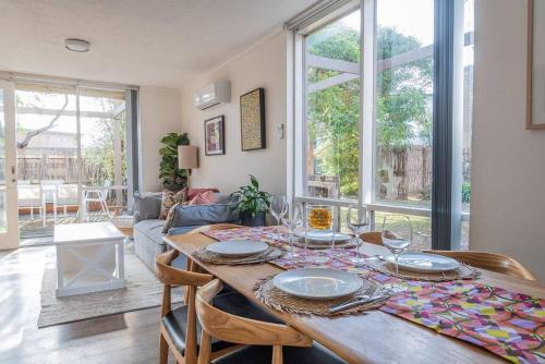 a dining room with a wooden table with plates on it at Cosy Corner Hideaway in Torquay