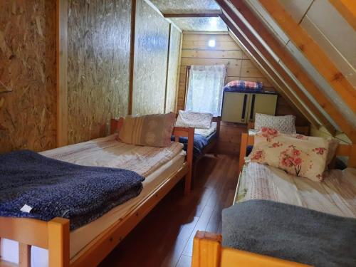 a room with two bunk beds in a cabin at Peaks of the Balkans Trail 192 km -- Hostel Panorama -- in Peje