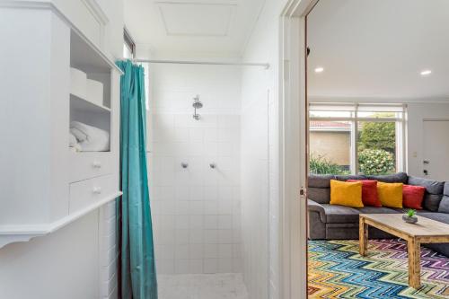 a bathroom with a shower and a couch at Fisherman's Rest in Emu Point