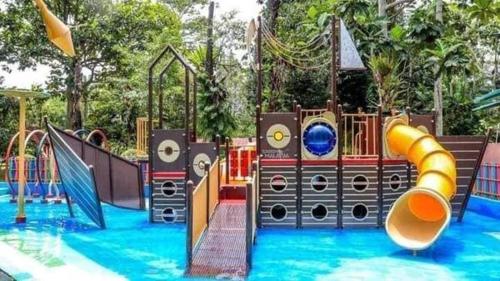 a water park with a playground with a slide and slides at Adiniz@HotSpring Sg Klah in Sungkai