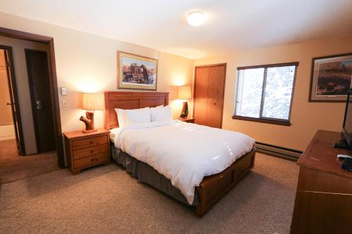 a bedroom with a large bed and a window at Trapper 8 in West Yellowstone