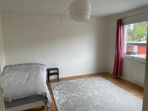 a bedroom with a bed and a window at Cozy Rooms between Airport&Center in Stockholm