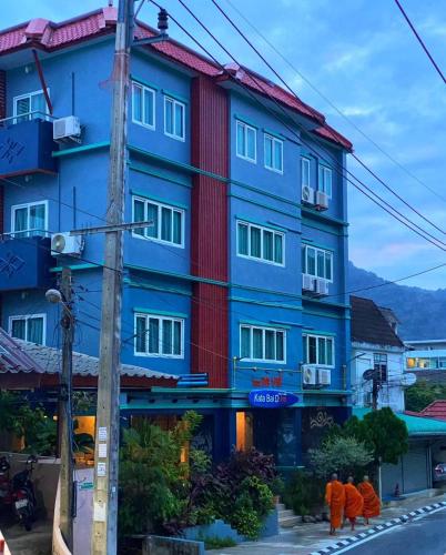 a colorful building on the side of a street at Kata Bai D - SHA Certificate Hotel in Kata Beach