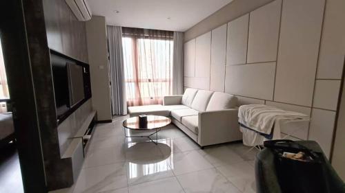 a living room with a couch and a table at 8 Kia Peng Central Suites in Kuala Lumpur