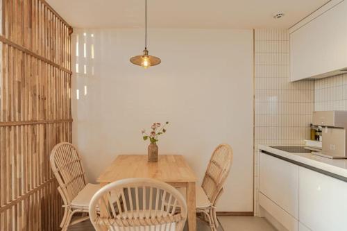a dining room with a wooden table and chairs at Le Village Aewol F in Jeju