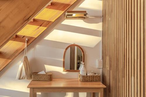 a bathroom with a mirror and a wooden table at Le Village Aewol F in Jeju