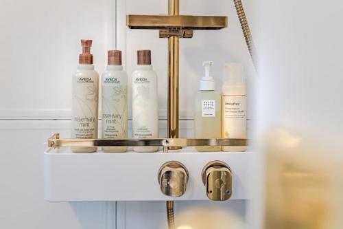 a shelf with several bottles of hair products on it at Le Village Aewol F in Jeju