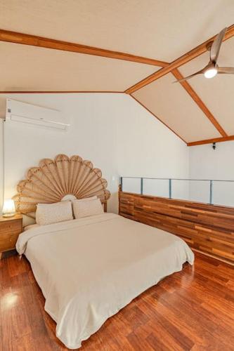 a bedroom with a large bed with a wooden headboard at Le Village Aewol F in Jeju
