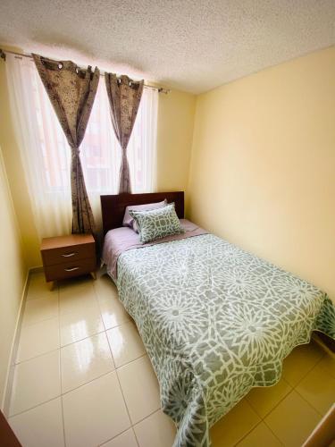 a small bedroom with a bed and a window at Apartamento Madrid cund in Madrid