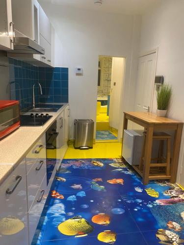 a kitchen with a floor with fish painted on it at Ziggla Luxury Apartments in London
