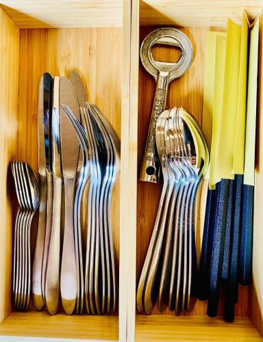 a wooden drawer with utensils in it at Private Villa ietona in Fujikawaguchiko