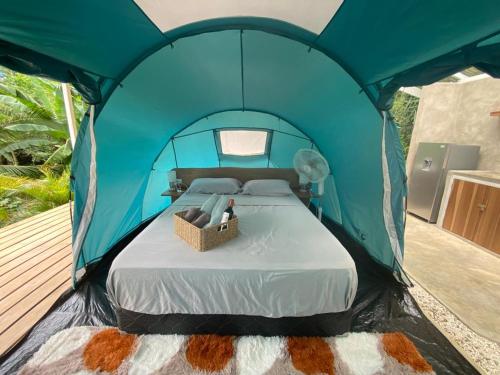 a blue tent with a bed in it at Serenity Glamping in Puerto Viejo