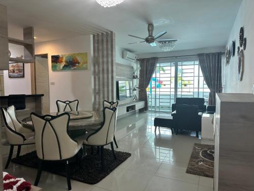 a living room with a dining room table and chairs at Hii's Cozy Homestay in Miri