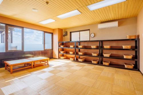a room with shelves and a table in it at Sado Resort Hotel Azuma in Sado
