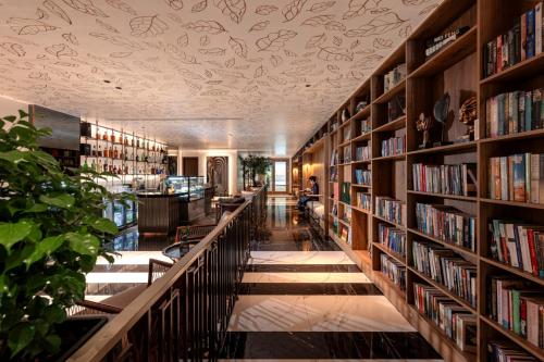 a library with lots of bookshelves at La Siesta Classic Hang Thung in Hanoi