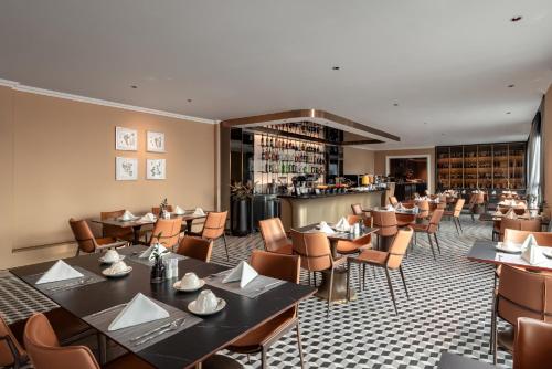 a restaurant with tables and chairs and a bar at La Siesta Classic Hang Thung in Hanoi