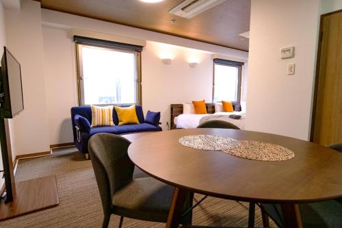 a living room with a table and a couch at J-Court Oshiage in Tokyo