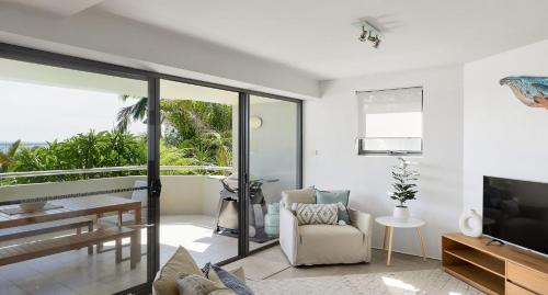 a living room with a couch and a television at The Drift in Nelson Bay