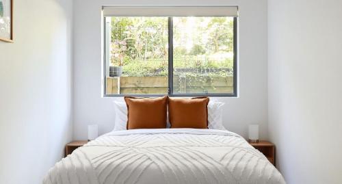 a bedroom with a bed and a window at The Shores in Nelson Bay