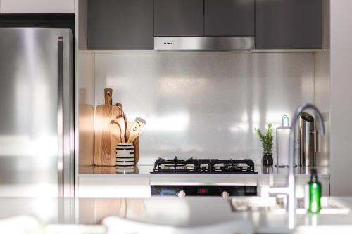a kitchen with a stainless steel stove top oven at The Hideaway in Newcastle