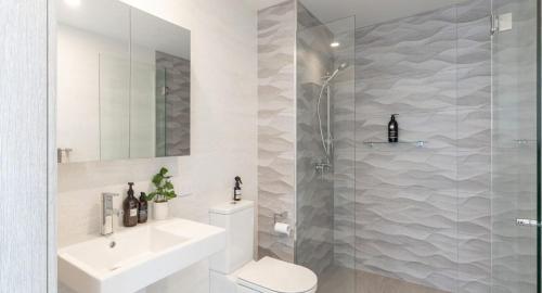 a bathroom with a shower and a toilet and a sink at The Outlook in Newcastle