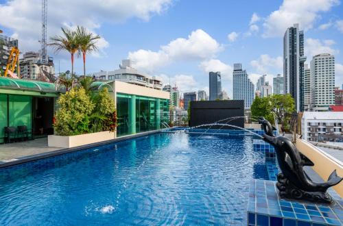 a swimming pool on top of a building with a city skyline at Admiral Premier Bangkok in Bangkok