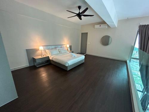 a bedroom with a bed and a ceiling fan at INAP DESA EVO BANGI in Bandar Baru Bangi