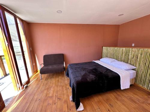 a bedroom with a bed and a chair in it at AMA WARA in Maimará