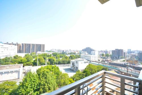 a balcony with a view of a city at Residence Hotel Hakata 8 in Fukuoka