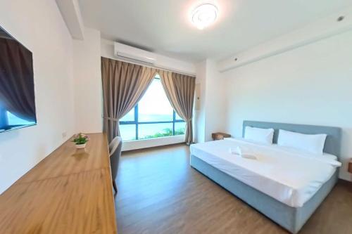a bedroom with a large bed and a large window at Carnelian Tower - Forest City FC4223 in Gelang Patah