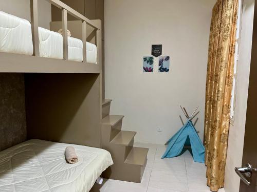 a bedroom with a bunk bed and a staircase at Bayu Apartment Services in Kuah