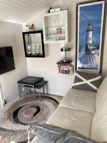 a room with a bed and a table and a television at Studio 51 Örgryte in Gothenburg