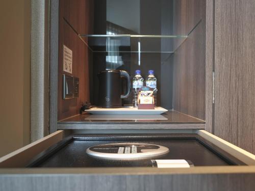 a microwave oven with a plate in a room at Amrise Hotel Kitchener in Singapore