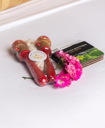 a hot dog and a book and flowers on a table at The Capoe House in Haputale