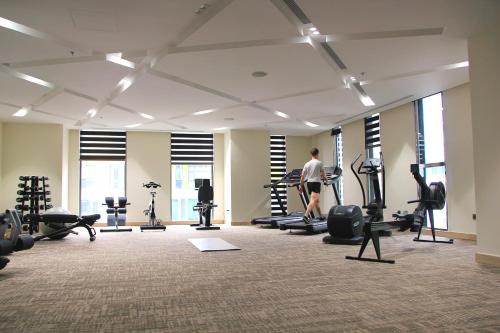 a man exercising in a gym with tread machines at The Art Nest Hotel Nha Trang in Nha Trang