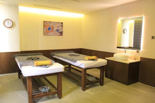 a bathroom with two massage tables and a sink at The Art Nest Hotel Nha Trang in Nha Trang