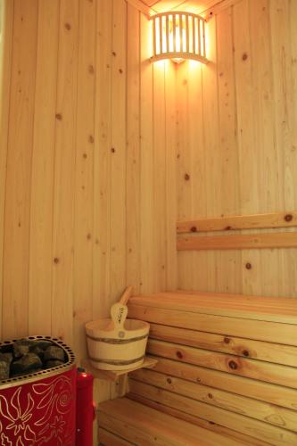 a wooden bathroom with a tub and a toilet at The Art Nest Hotel Nha Trang in Nha Trang