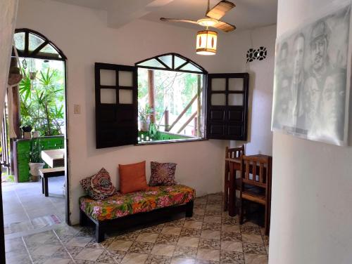 a living room with a couch and a window at Jurema Hostel in Itacaré