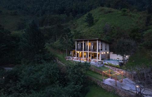 a house on the side of a hill at night at The Capoe House in Haputale