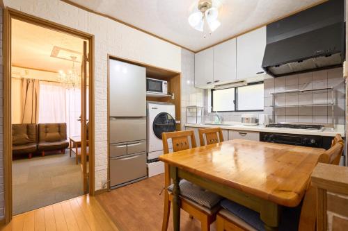 a kitchen with a wooden table and a dining room at Morden stylish villa--Max12p--2Bathrooms--Free wifi in Tokyo