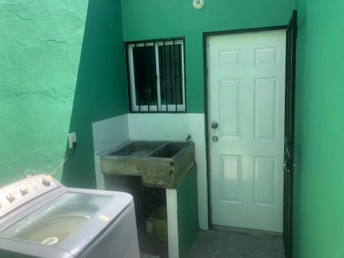 a bathroom with a sink and a white door at casa para descansar o vacacionar in Mazatlán