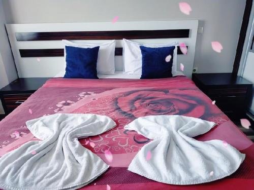 a bed with two white towels on top of it at Home in love in Esenyurt