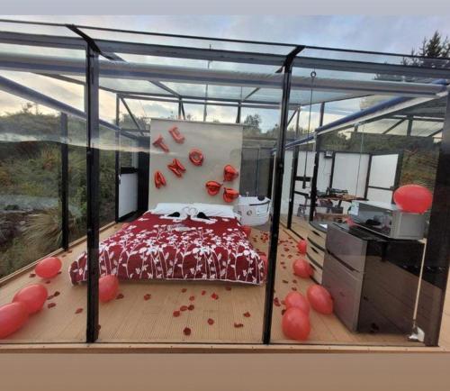 a bedroom with a bed on a deck with red decorations at CotopaxGlam in Latacunga