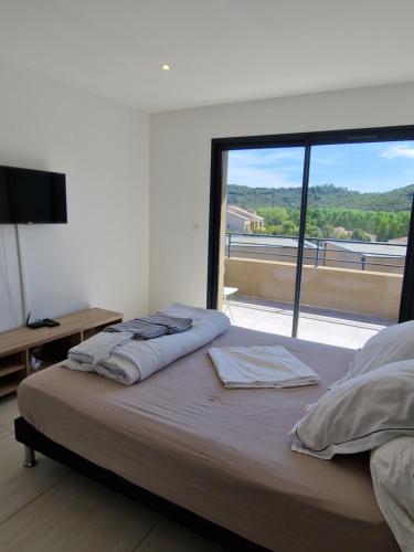 Schlafzimmer mit einem Bett und einem großen Fenster in der Unterkunft Villa Favone 4 chambres piscine privée in Conca